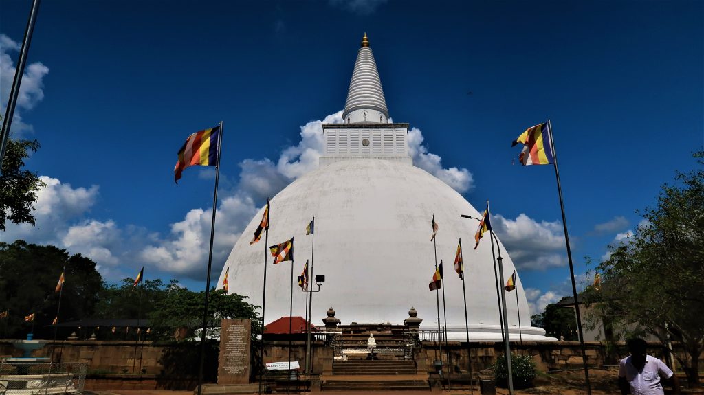 Bright white Buddhist stupa on the way to temple in Annuradapura