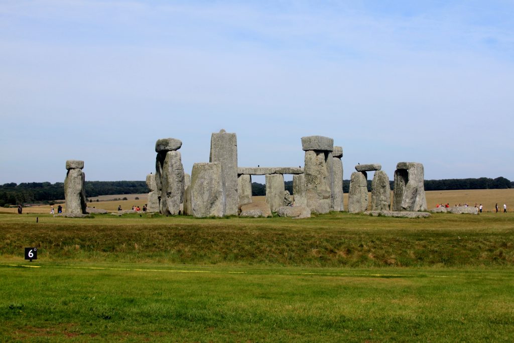 A number of stones set out in a circular shape, with a hazzy sky. This is known as Stonehenge in the UK.